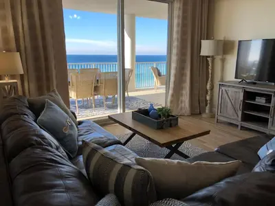 a living room with a couch and a view of the ocean at Ocean Ritz - Family Tides - sleeps 12 in Panama City Beach