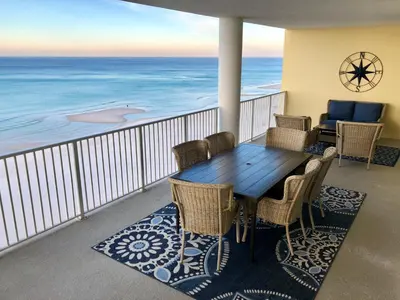 a table and chairs on a balcony with the ocean at Ocean Ritz - Family Tides - sleeps 12 in Panama City Beach