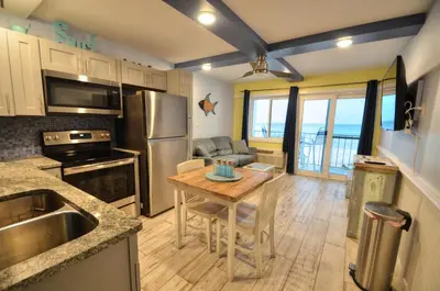 a kitchen with a table and a dining room at Emerald Villa in Panama City Beach