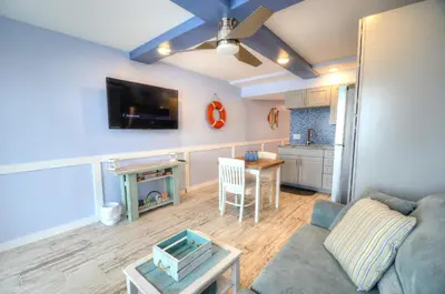 a living room with a couch and a table at Emerald Villa in Panama City Beach