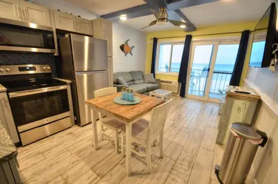 a kitchen with a table and a couch at Emerald Villa in Panama City Beach