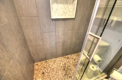 a shower stall with a toilet in a bathroom at Emerald Villa in Panama City Beach