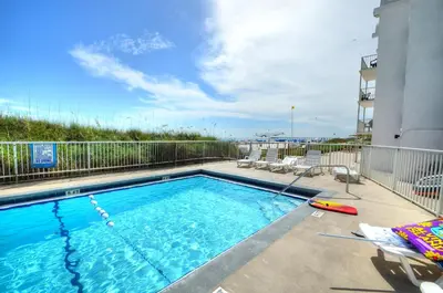a large swimming pool with chairs at Emerald Villa in Panama City Beach