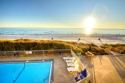 a view of the beach with a swimming pool and the ocean at Emerald Villa in Panama City Beach