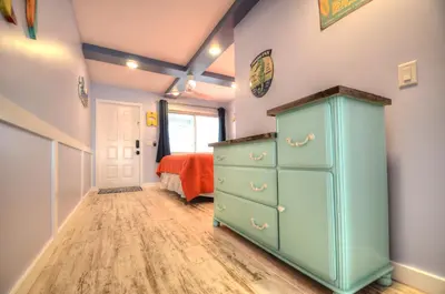 a bedroom with a blue dresser and a bed at Emerald Villa in Panama City Beach