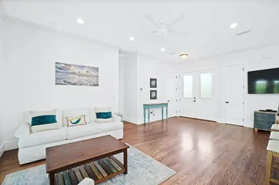 a living room with a white couch and a table at 30A Beach House - Caspian Sea-duction in Sunnyside