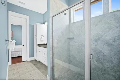 a bathroom with a shower and a glass door at 30A Beach House - Caspian Sea-duction in Sunnyside