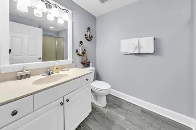 a white bathroom with a sink and a toilet at Tidewater 314 NEW in Panama City Beach