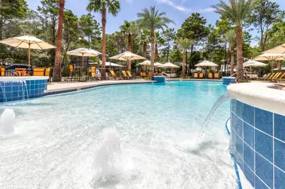 a swimming pool at a resort with a fountain at Magnolia Cottages by the Sea by Panhandle Getaways in Watersound Beach