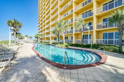 a swimming pool in front of a building at Calypso Beach Resort Towers in Panama City Beach