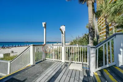 a wooden deck with the beach in the background at Calypso Beach Resort Towers in Panama City Beach