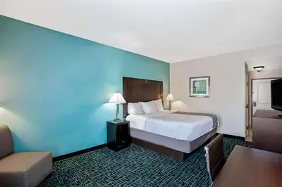 a hotel room with a bed and a couch at La Quinta by Wyndham PCB Pier Park area in Panama City Beach