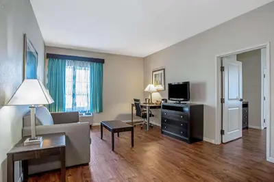 a living room with a couch and a tv at La Quinta by Wyndham PCB Pier Park area in Panama City Beach