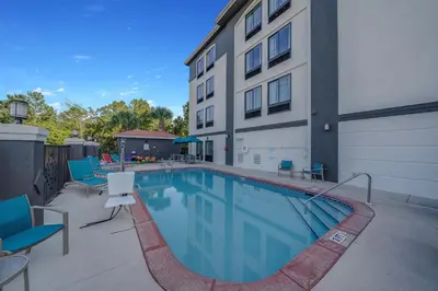 a swimming pool in front of a building at La Quinta by Wyndham PCB Pier Park area in Panama City Beach