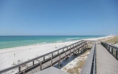a boardwalk leading to a beach with the ocean at Prominence on 30A Vacation Homes in Watersound Beach
