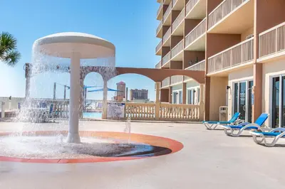 a fountain in the middle of a courtyard with chairs at Sunrise Beach #910 in Panama City Beach