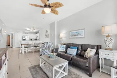 a living room with a couch and a table at Sunrise Beach #910 in Panama City Beach