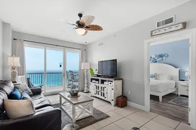 a living room with a couch and a television at Sunrise Beach #910 in Panama City Beach