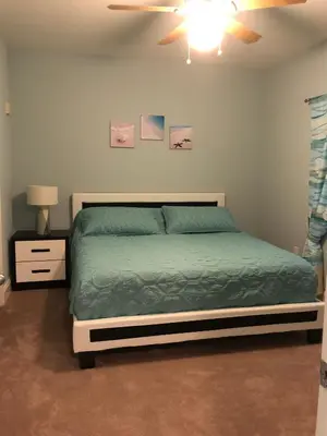a bedroom with a bed and a ceiling fan at Snowbirds are welcome Laketown Wharf Resort 2 and 3 flrs in Panama City Beach