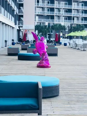 a pink unicorn statue sitting in the middle of a courtyard at Snowbirds are welcome Laketown Wharf Resort 2 and 3 flrs in Panama City Beach