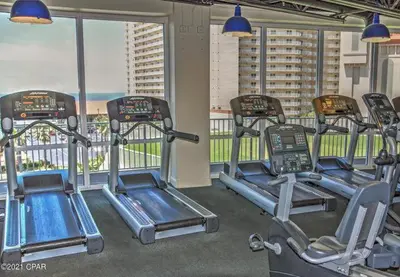 a gym with three exercise bikes in a room at Snowbirds are welcome Laketown Wharf Resort 2 and 3 flrs in Panama City Beach