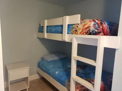 a bunk bed in a room with a bunk bedutenewayewayangering at Snowbirds are welcome Laketown Wharf Resort 2 and 3 flrs in Panama City Beach