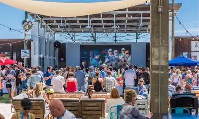 a crowd of people standing in front of a stage at Prominence Rentals on 30A by Panhandle Getaways in Watersound Beach