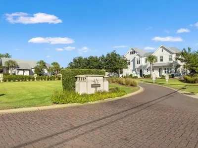 a brick road in a residential neighborhood with houses at Prominence Rentals on 30A by Panhandle Getaways in Watersound Beach