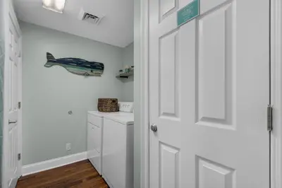 a white bathroom with a white door and a sink at Calypso 1-608 East in Panama City Beach