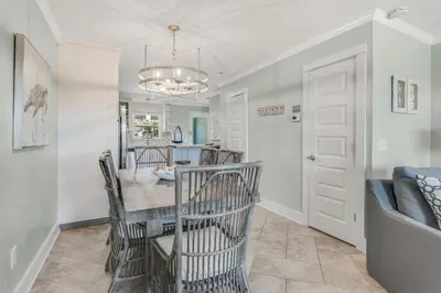 a dining room and living room with a table and chairs at Sunnyside on the Gulf #3 in Sunnyside