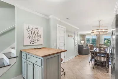 a kitchen and living room with a table and a dining room at Sunnyside on the Gulf #3 in Sunnyside