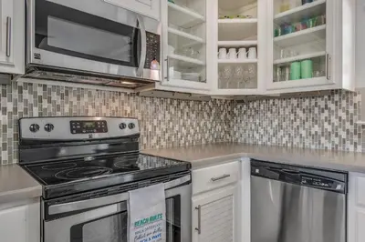 a kitchen with a stove and a microwave at Sunnyside on the Gulf #3 in Sunnyside