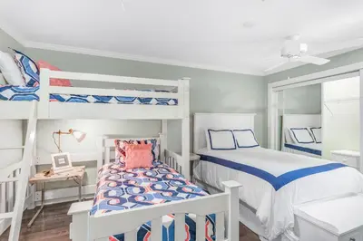 a bedroom with two bunk beds and a small bed at Sunnyside on the Gulf #3 in Sunnyside