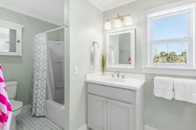 a white bathroom with a sink and a shower at Sunnyside on the Gulf #3 in Sunnyside