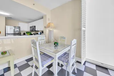 a kitchen and dining room with a table and chairs at Majestic Beach Towers 1-1615 in Panama City Beach