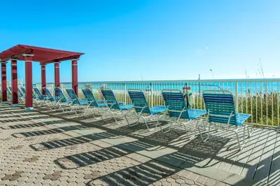 a row of chairs sitting on the beach at Majestic Beach Towers 1-1615 in Panama City Beach
