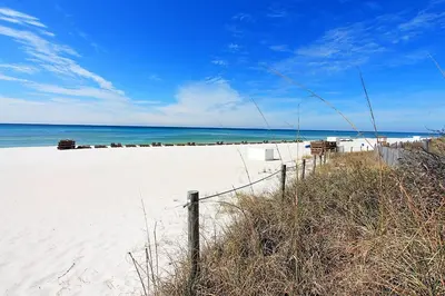 a sandy beach with a fence and the ocean at Majestic Beach Towers 1-1615 in Panama City Beach