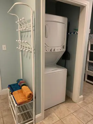 a refrigerator with a towel and a microwave in a room at LAKETOWN 5 POOLs STEPS TO BEACH FAMILY FRIENDLY in Panama City Beach