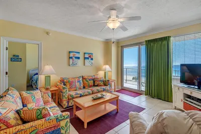 a living room with a couch and a tv at Oceanfront Condo with Spacious Balcony - Unit 0306 in Panama City Beach