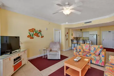 a living room with a couch and a flat screen tv at Oceanfront Condo with Spacious Balcony - Unit 0306 in Panama City Beach