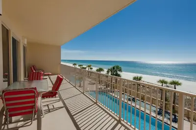 a balcony with a table and chairs and the beach at Oceanfront Condo with Spacious Balcony - Unit 0306 in Panama City Beach