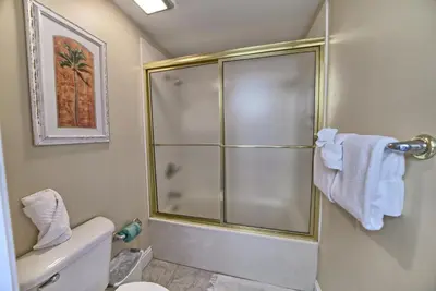 a bathroom with a shower with a white toilet at Beautiful Beachfront Condo with Pool View - Unit 0203 in Panama City Beach
