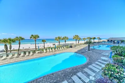 an overhead view of a swimming pool with chairs and the beach at Beautiful Beachfront Condo with Pool View - Unit 0203 in Panama City Beach