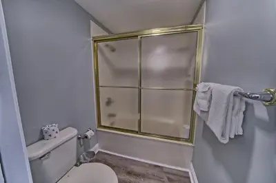 a bathroom with a toilet and a glass shower at Gorgeous Condo with Breathtaking Ocean View - Unit 0803 in Panama City Beach