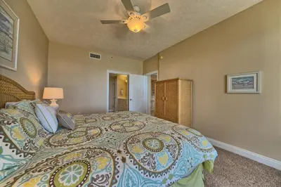 a bedroom with a bed and a ceiling fan at Comfortable High-Rise Condo with Beach Access - Unit 1404 in Panama City Beach