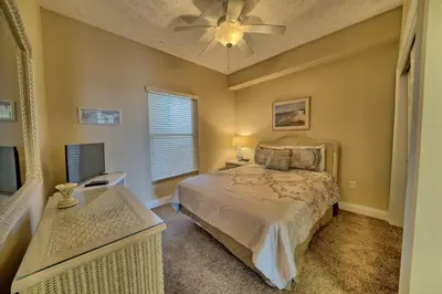 a bedroom with a bed and a ceiling fan at Comfortable High-Rise Condo with Beach Access - Unit 1404 in Panama City Beach