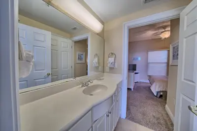 a bathroom with a sink and a large mirror at Comfortable High-Rise Condo with Beach Access - Unit 1404 in Panama City Beach