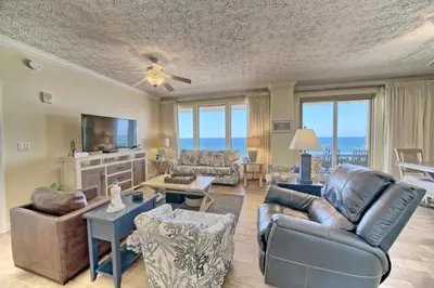 a living room with a couch and chairs and a television at Roomy Condo with Pool and Beach Access - Unit 0502 in Panama City Beach