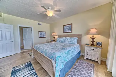a bedroom with a bed and a ceiling fan at Roomy Condo with Pool and Beach Access - Unit 0502 in Panama City Beach