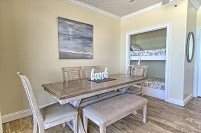 a dining room with a wooden table and chairs at Roomy Condo with Pool and Beach Access - Unit 0502 in Panama City Beach